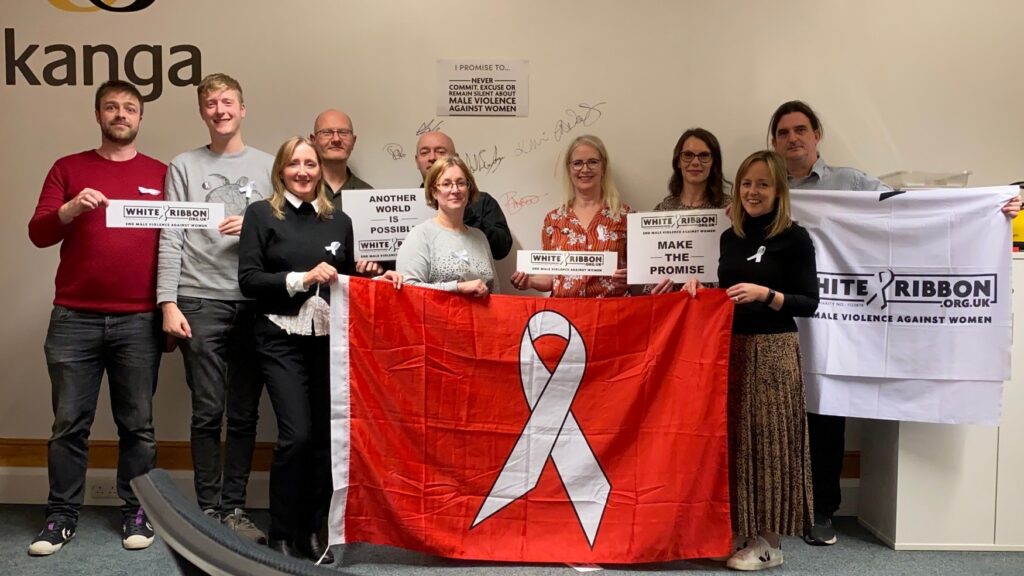 Kanga staff wearing White Ribbons and holding White Ribbon banners, flags and posters.